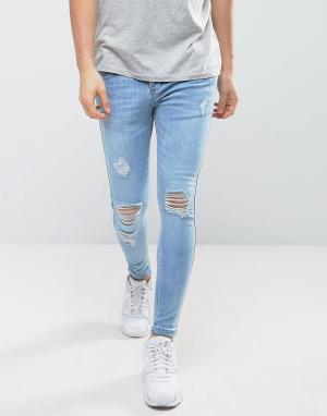 Обтягивающие джинсы с дырками на коленях SikSilk. Цвет: синий