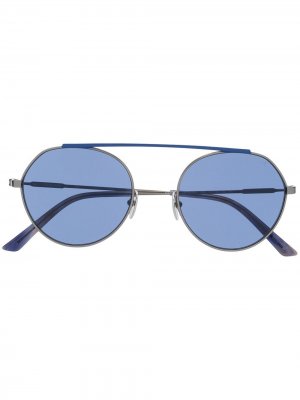 Солнцезащитные очки в круглой оправе Calvin Klein. Цвет: синий