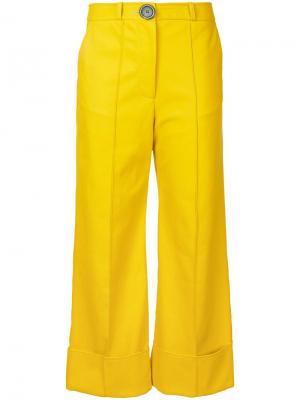 Расклешенные укороченные брюки A.W.A.K.E.. Цвет: желтый